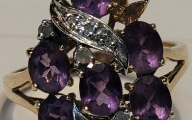 An amethyst and diamond cluster ring in 14k yellow and...