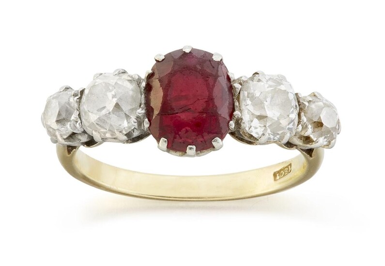 An early 20th century gold, Ruby and diamond five stone ring, the central claw-set oval-cut ruby flanked by two old-brilliant-cut diamonds with further smaller diamond single stone shoulders, ring size L1/2