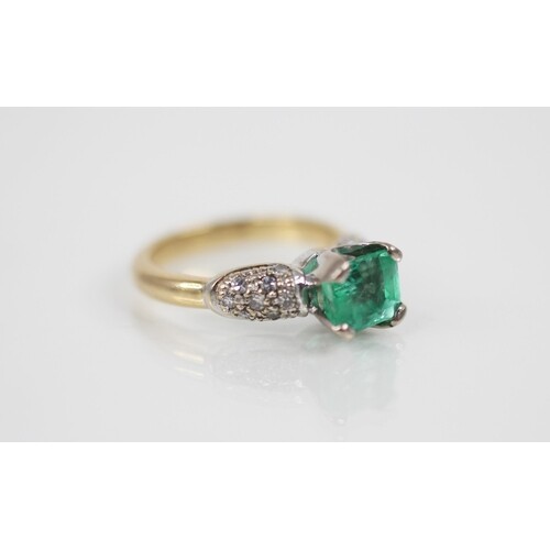 An emerald and diamond ring, the central octagonal step cut ...