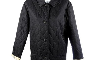 BURBERRY - a woman's black quilted jacket. Featuring