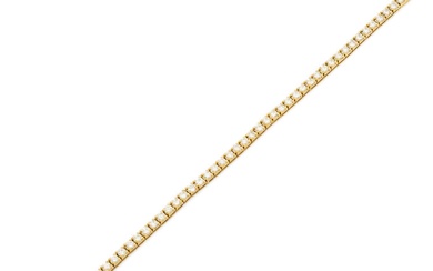 Bracelet ligne en or jaune 18k (750‰) orné de 50 diamants ronds de taille brillant...