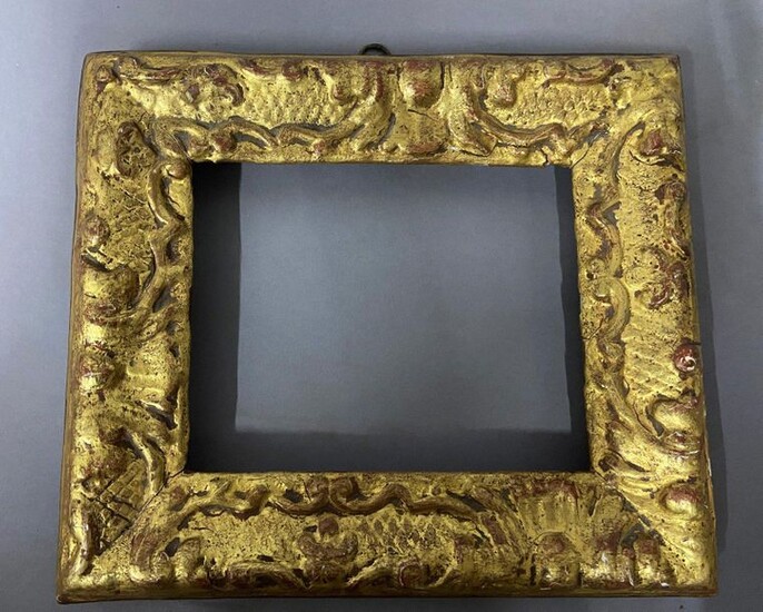 Carved and gilded wood frame with Bérain decoration