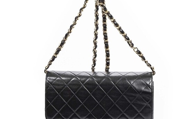 Chanel A “Single Flap” bag of black quilted leather with gold tone...