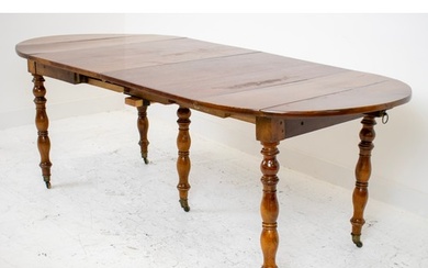 DINING TABLE, mid 19th century French walnut with drop flaps...