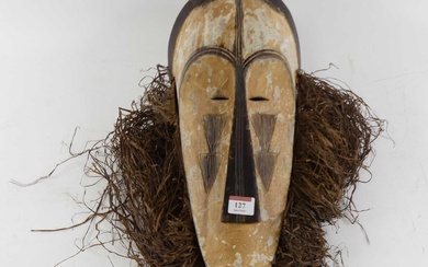 Lot details A West African carved wood Ngil judicial mask,...