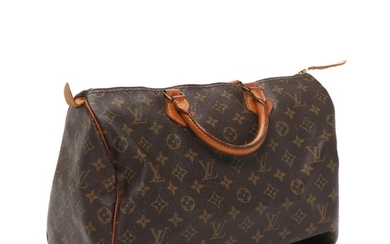 Louis Vuitton: A “Speedy 35” bag of brown monogram canvas, leather trimmings and handle, golden hardware, one large zipped compartment with and open pocket.