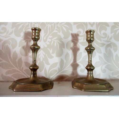 Pair of C18th cast brass candlesticks with spool shaped scon...