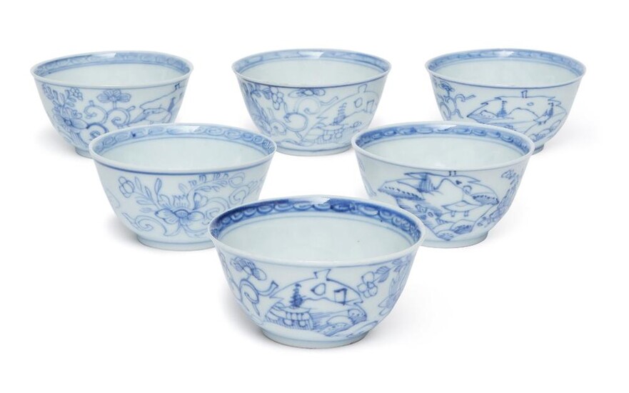 Six Chinese blue and white tea cups, 18th century, each with deep sides rising to slightly flared rim, painted to the inside with a flower in the central roundel and a band of key fret to the rim, the exterior painted in between two lines with...