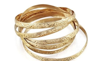 Six bangles, of matching hoop design with scroll decoration, one...