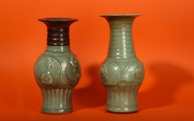 TWO CHINESE LONGQUAN CELADON MOULDED VASES. Yuan Dynasty. Each with an ovoid body decorated with an undulating floral stem and carved with vertical ribs around the foot, the flared neck with plain horizontal bands, decorated with an even celadon glaze...