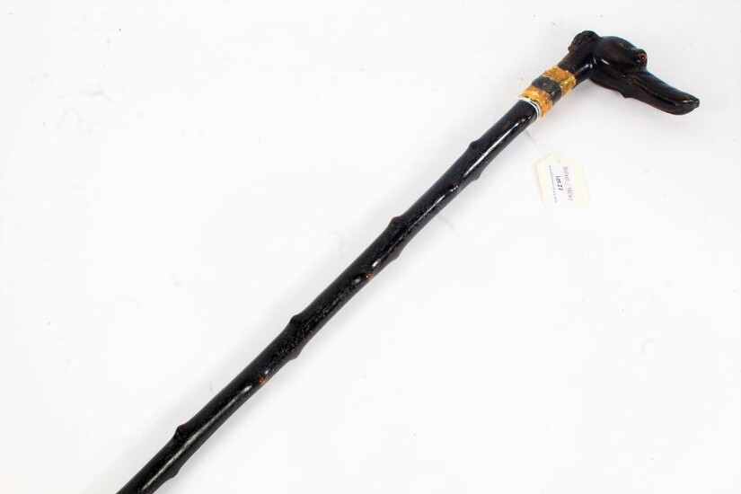 Victorian carved cane, carved with a dog head handle and glass eyes, 83cm long