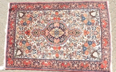 A PERSIAN BIDJAR RUG with a floral centre, motif and