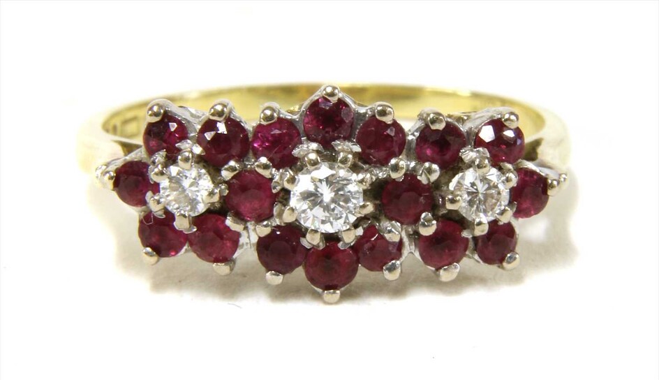 An 18ct gold diamond and ruby triple cluster ring
