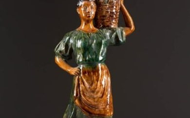 A CERAMIC FIGURE OF A PEASANT WOMAN WITH GRAPES' Soviet
