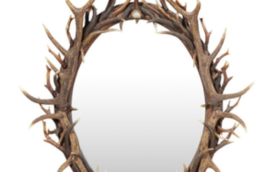 AN ANTLER FRAMED OVAL MIRROR CONTEMPORARY the oval mirrored...