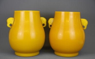 A superb pair of Chinese Imperial yellow Peking glass jars with elephant head handles, H. 27cm.