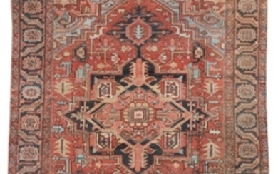 ORIENTAL RUG: HERIZ 7'7" x 9'7" Abrashed charcoal, light gold and salmon pink gabled medallion on an abrashed red field with stylize.