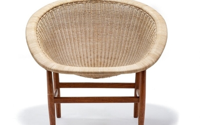 Nanna Ditzel: Easy chair with teak frame mounted on tapering legs. Seat, back and sides of woven cane. Made by cabinetmaker Ludvig Pontoppidan.