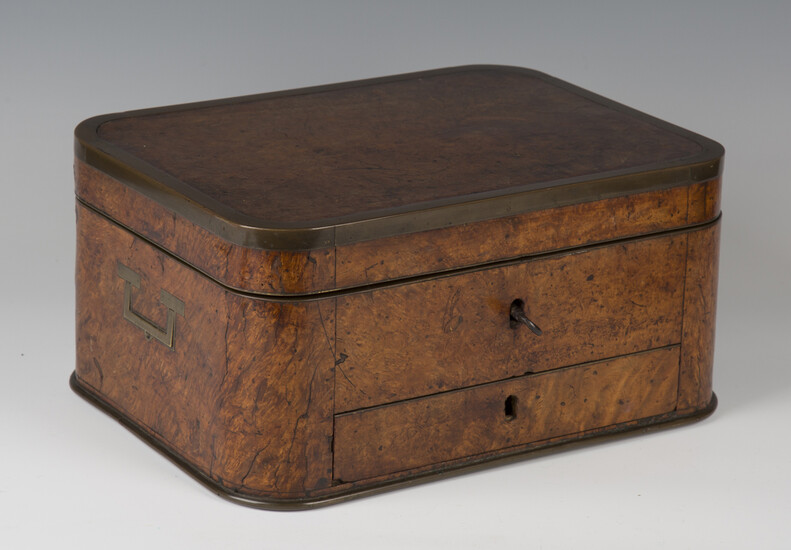 A 19th century Colonial burr walnut and brass bound campaign dressing box of curved rectangular form