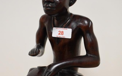 A 20th century African carved hardwood seated tribal drummer figure, approx 27cm.