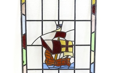 A 20thC stained glass panel depicting a sailing ship with fl...