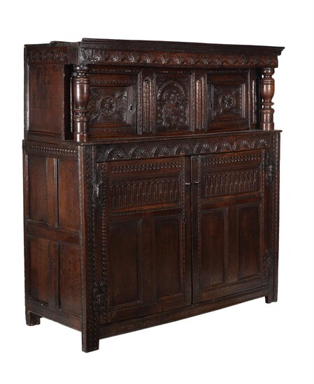 A Charles II carved oak court cupboard
