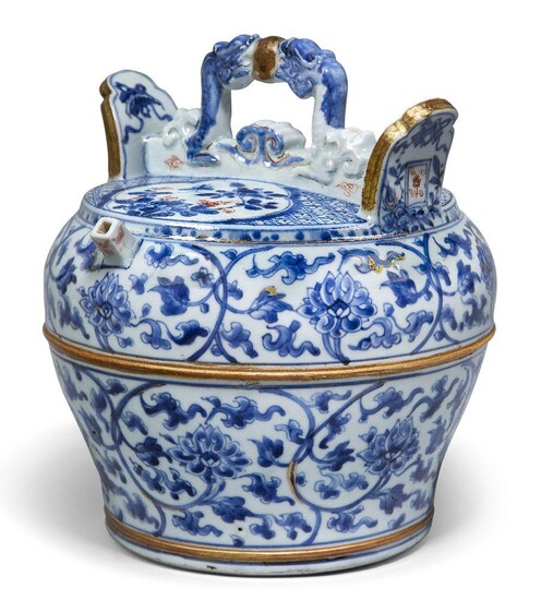 A Chinese porcelain blue and white barrel-form water vessel, early 18th century, the handle moulded as two confronting dragons between a gilt painted pearl, with short square spout flanked by two everted flanges, the body painted with continuous...