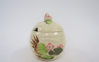 A Clarice Cliff Newport pottery lidded preserve jar in the W...