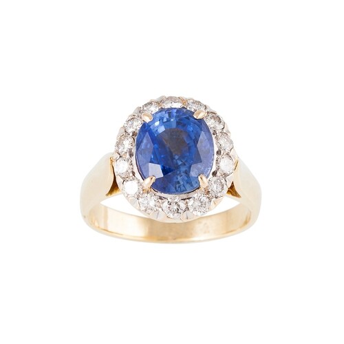 A DIAMOND AND SAPPHIRE CLUSTER RING, the oval sapphire to a ...