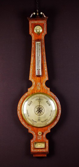 A Fine 19th Century Wheel Barometer by Gatty, High Holborn London. The rosewood case inlaid with and