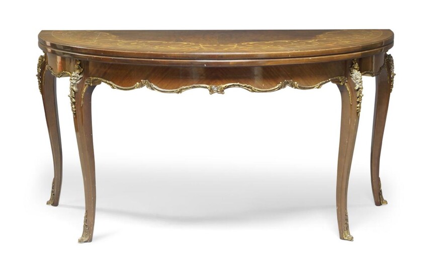 A French Louis XV style marquetry and gilt metal mounted fold-over demi-lune table, of recent manufacture, the top with book-matched decorative walnut veneers, scrolled and floral marquetry of natural and dyed satinwood, stringing to edge, the top...