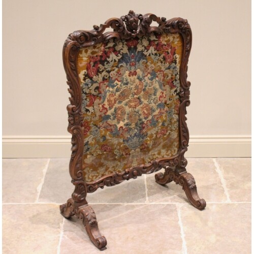 A French walnut fire screen, 19th century, the Rococo leaf s...