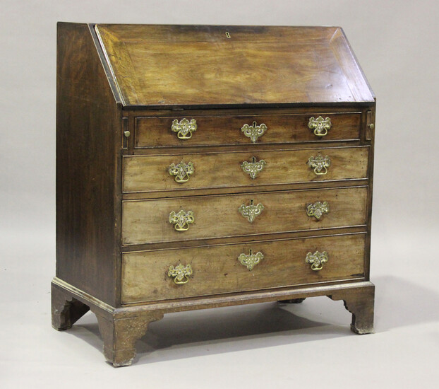 A George III mahogany bureau, the fall flap revealing an interior fitted with pigeonholes, cupboard