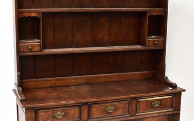 A Georgian-style oak dresser with boarded plate rack incorporating two...