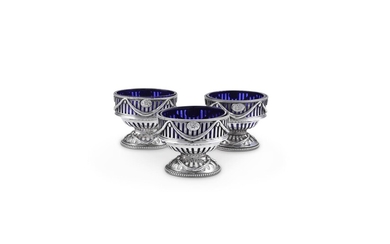 A MATCHED SET OF THREE GEORGE III SILVER OVAL PEDESTAL SALT CELLARS BY ROBERT HENNELL I
