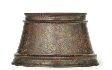 A Mamluk silver-inlaid bronze candlestick base Egypt or Syria, 14th...