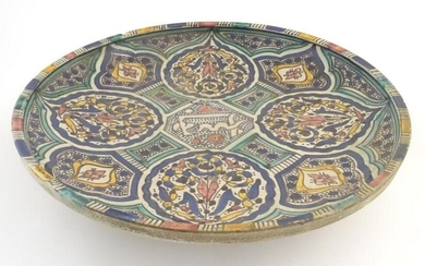 A Moroccan charger with panelled geometric designs with