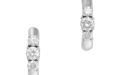 A PAIR OF DIAMOND HOOP EARRINGS each designed as a hoop set with three round brilliant cut diamonds