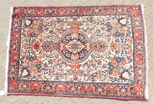 A PERSIAN BIDJAR RUG with a floral centre, motif and