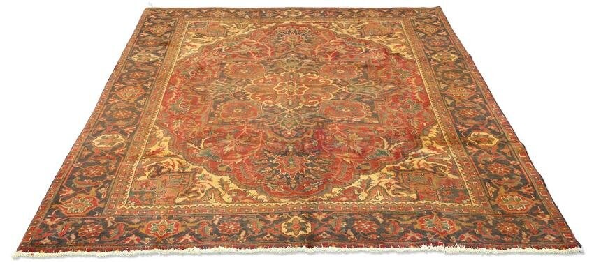A PERSIAN HERIZ CARPET, hand-knotted, the deep red