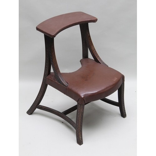 A PROBABLE 19TH CENTURY CHAIR OF PURPOSE having brown leathe...