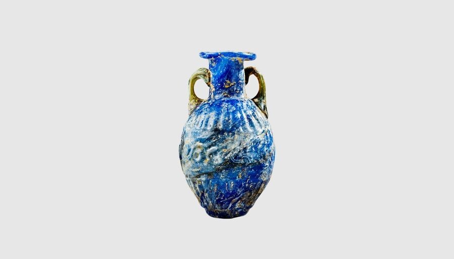 A Roman blue glass amphoriskos. 1st century AD....