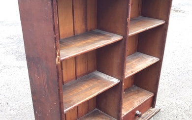 A Victorian mahogany bookcase with moulded cornice above open shelves...