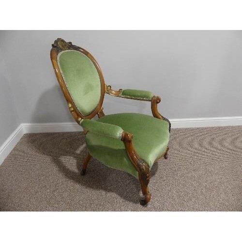 A Victorian walnut showframe open Armchair, with gilt carved...
