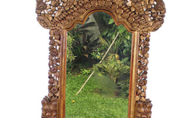 A carved gilt teak chest and mirror