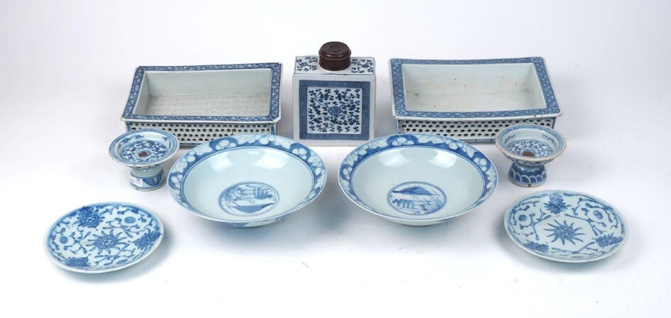 A collection of Chinese blue and white porcelain, late 19th/early 20th century, comprising: a tea caddy with turned wooden cover, total 15cm high; two dishes, marked to bases, 14.5cm diameter; two stem bowls with scrolling floral decoration, with...