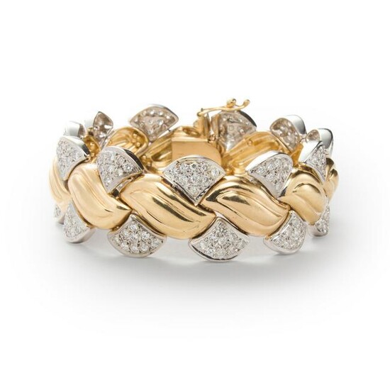 A diamond and fourteen karat bi-color gold bracelet