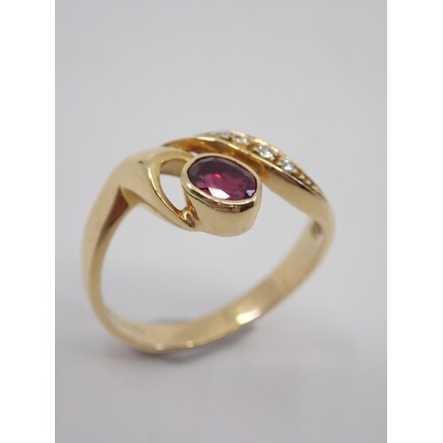 A diamond and ruby cluster ring set in 18ct gold, total esti...