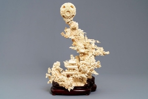 A fine Chinese ivory landscape with a puzzle ball,…