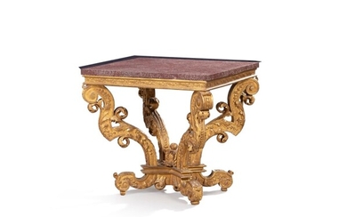 A giltwood center table, French Regence style, with a porphyry top | Table de milieu en bois doré de style Régence, avec un plateau en porphyre massif
